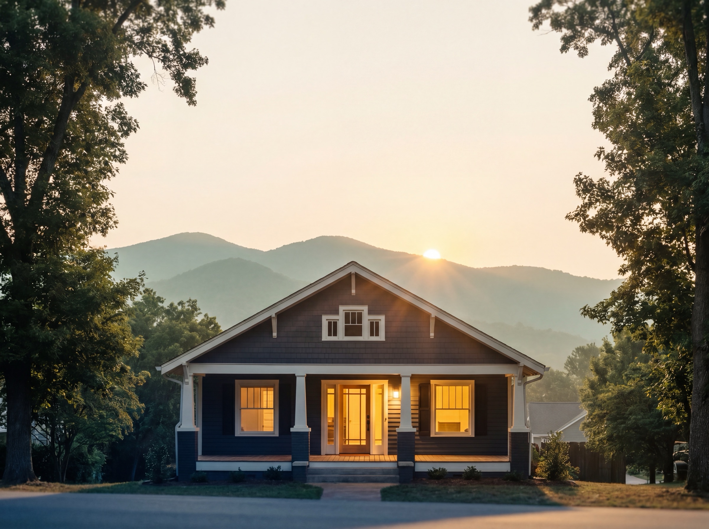 A welcoming home with a lit front porch at sunset
